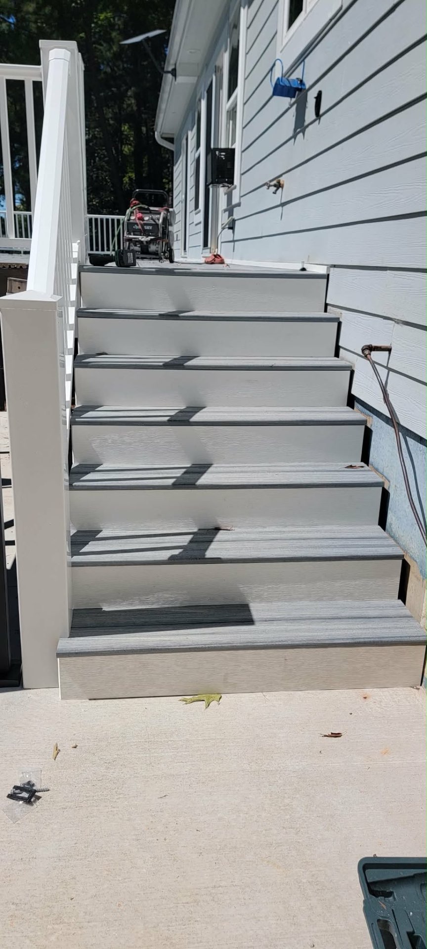 New composite stair set with gray treads and white railing