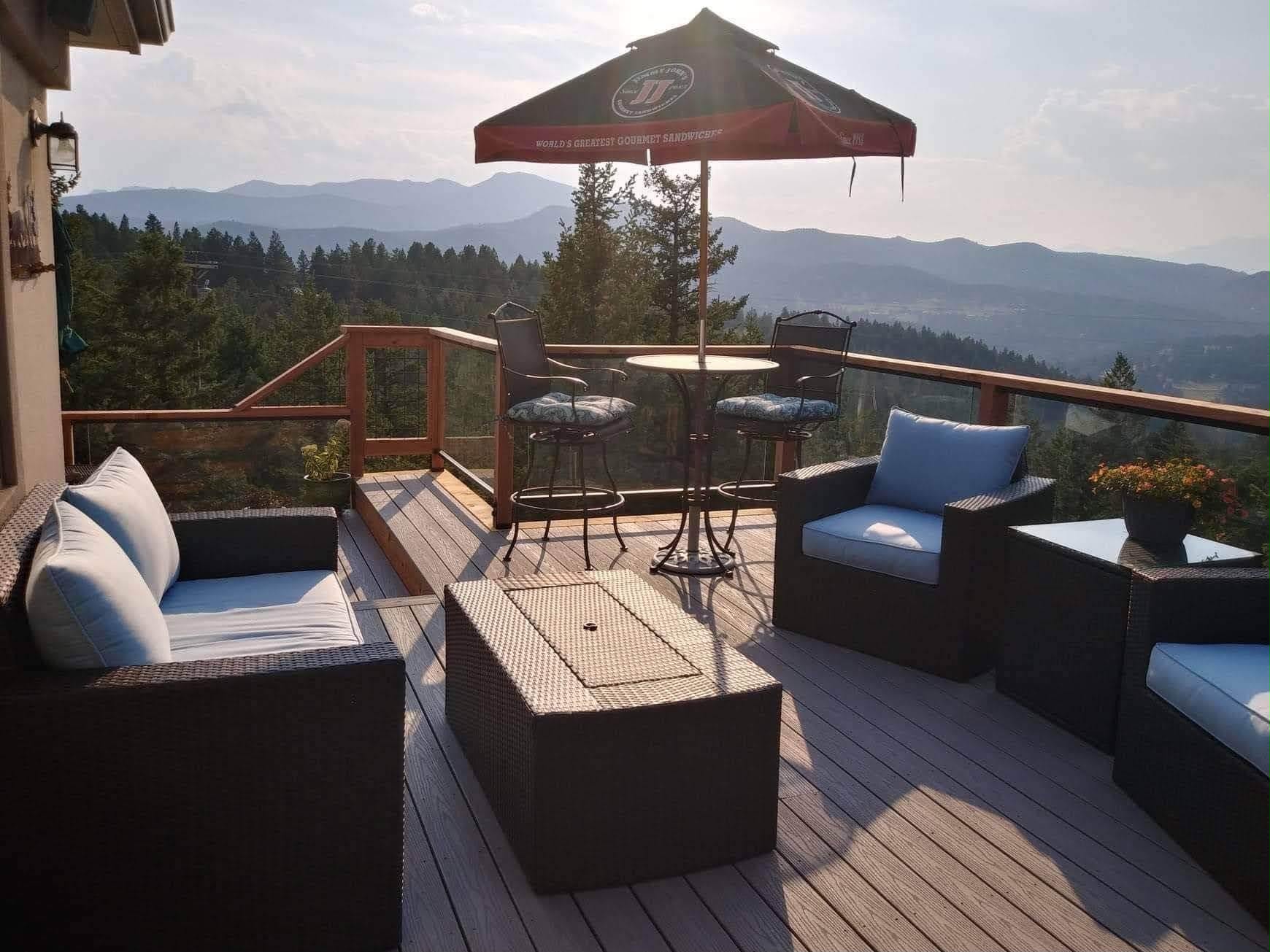 Composite deck with wood accent trim overlooking Rocky Mountains